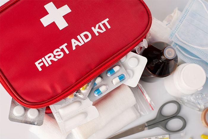 close up of a red first aid kit containing medical supplies and bacteriostatic water